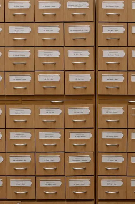 Vertical shot of labeled wooden file drawers for efficient organization